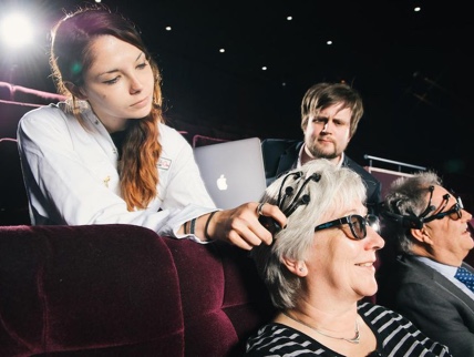 Image depicting researchers putting a wireless headset on a participant